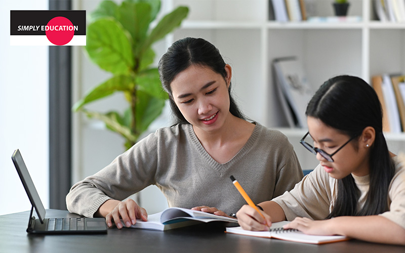 A teacher helping a student with their homework.