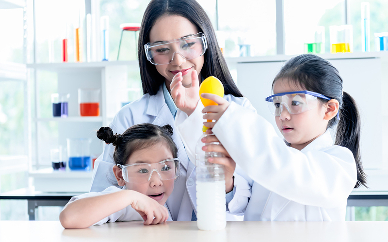 Students conducting science experiments to apply classroom learning practically.