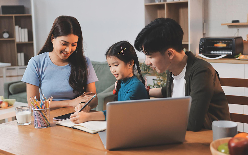 Parents helping a student with homework for tuition classes.